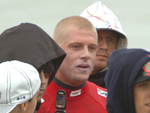 Mick Fanning cercado pelos fs ao sair do mar