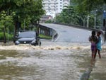 Veculo tenta passar por rua completamente tomada pela gua no bairro Lagoa, no Rio