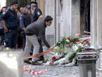 Pessoas depositam flores nas portas da sucursal do banco Marfin-Egnatia em Atenas (Grcia), onde trs pessoas morreram em incndio